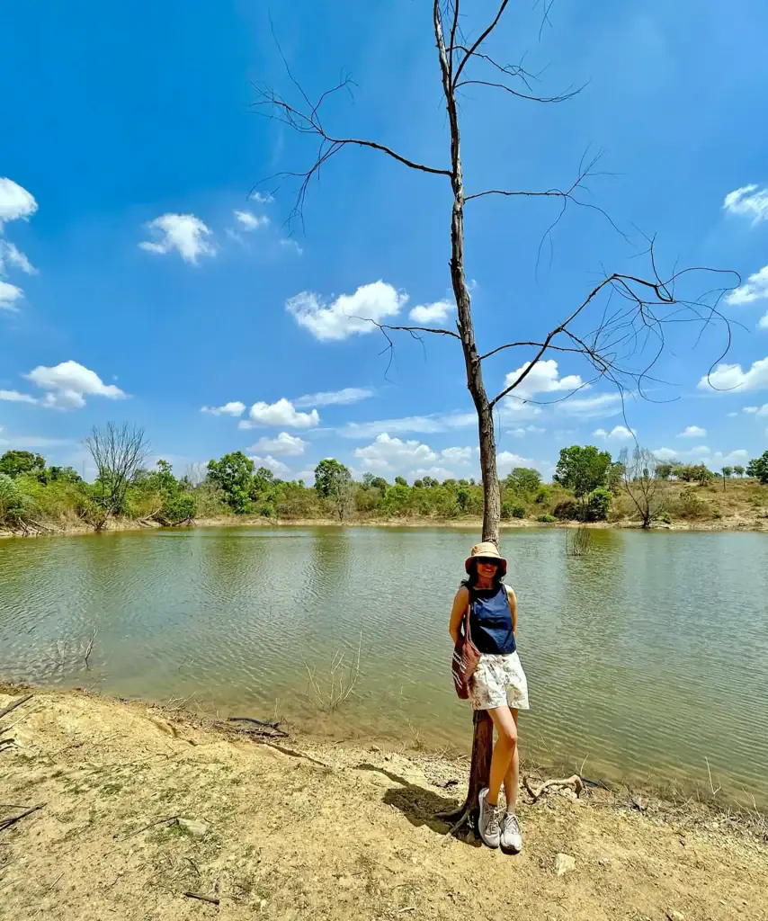 Lady posing next to the lake near Earthness on a sunny day